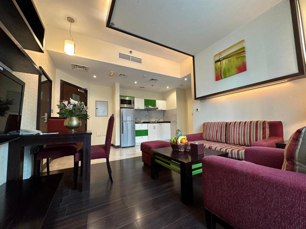 a living room with a couch and a table at Marina View Deluxe Hotel Apartment in Dubai
