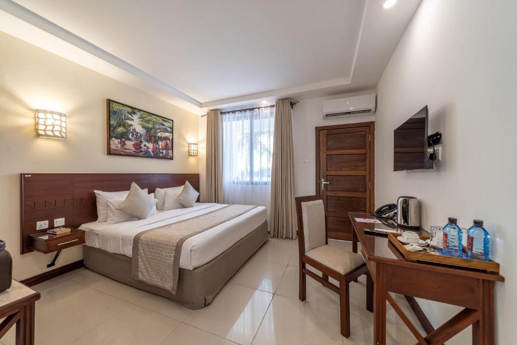 Postel nebo postele na pokoji v ubytování PrideInn Hotel Diani