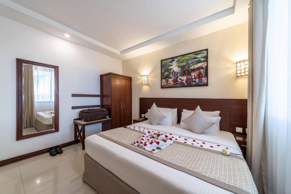 Postel nebo postele na pokoji v ubytování PrideInn Hotel Diani