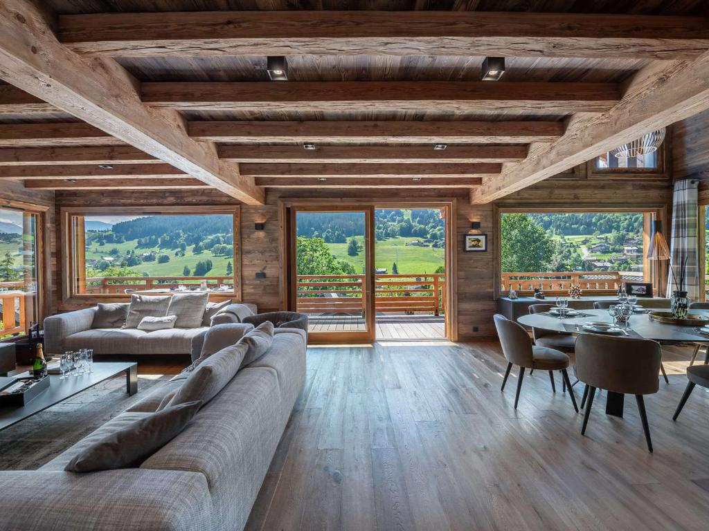 a living room with a couch and tables and windows at Chalet Demi-Quartier, 7 pièces, 12 personnes - FR-1-569-19 in Demi-Quartier