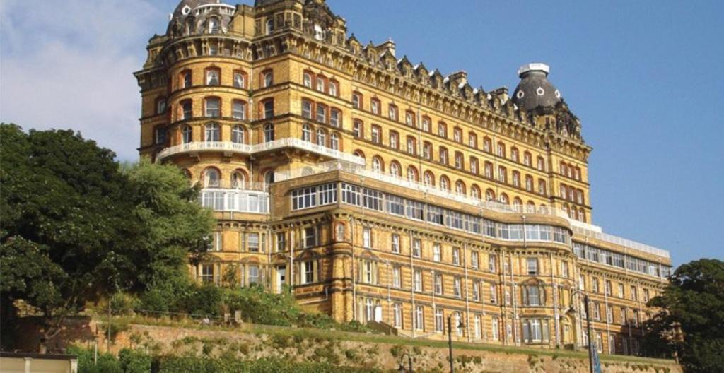 a large yellow building on top of a hill at The Grand Scarborough in Scarborough