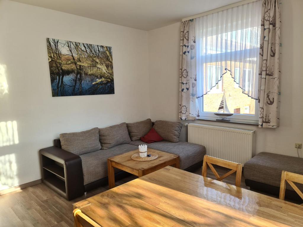 ein Wohnzimmer mit einem Sofa und einem Tisch in der Unterkunft Seevilla Wietjes Whg 2 in Baltrum