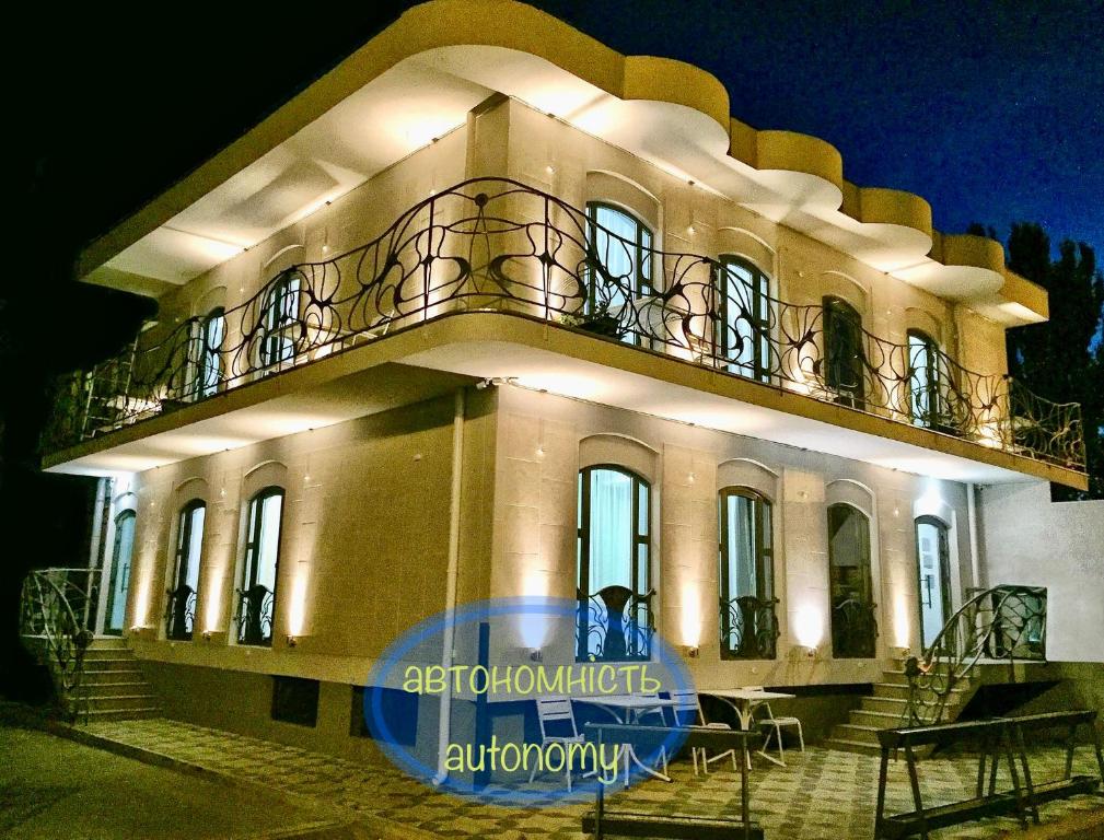 a building with a balcony on top of it at night at Gaudi stylish hotel in Odesa