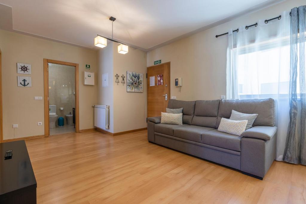 a living room with a couch and a window at Casa no Sitio in Nazaré