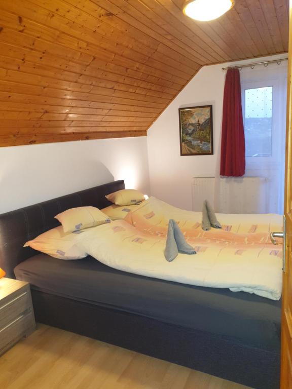 a bedroom with a large bed in a room at Vilmos Pince Fogadó in Hévíz