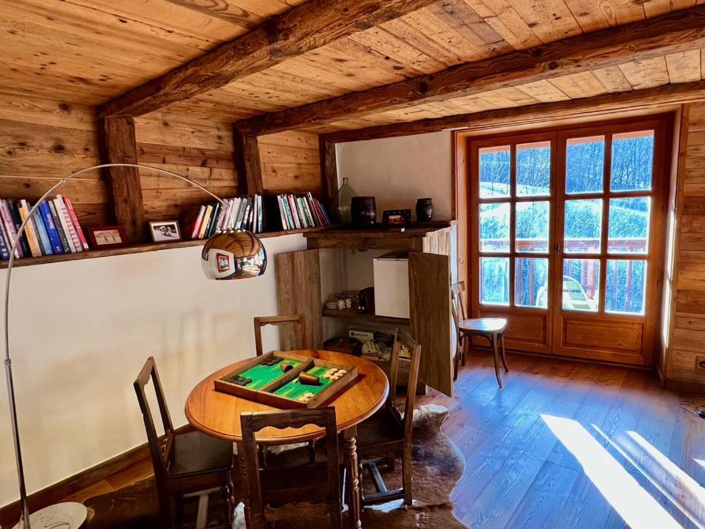 a dining room with a table and chairs in a cabin at Chalet Altus in Sainte-Foy-Tarentaise
