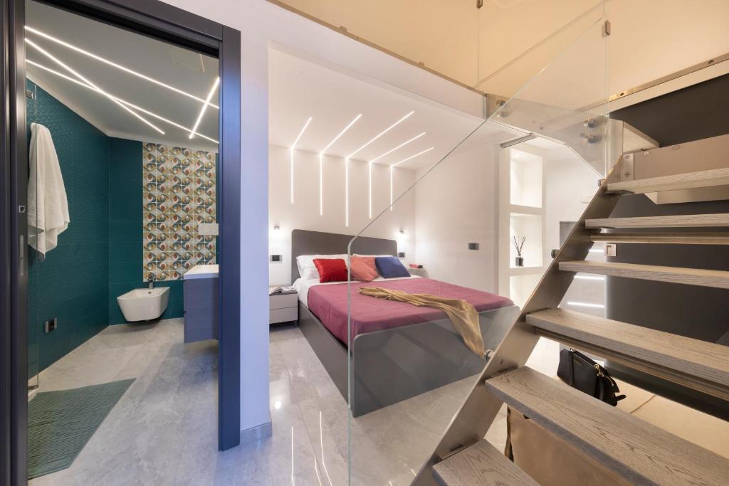 a bedroom with a bed and a staircase in a room at CASA LUCKY CENTRAL APARTMENT in Piano di Sorrento