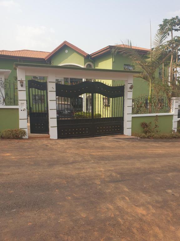 a house with a gate in front of it at PN Meublés FULL OPTION Odza Dispose d'une voiture et un chauffeur gratuitement de l,aéroport aux appartements pour des réservations minimum de 7 jours in Yaoundé