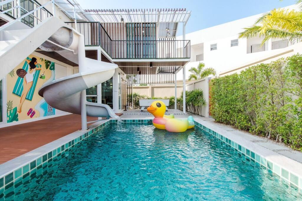 - une piscine avec toboggan dans un bâtiment dans l'établissement Poollay StayX4 Poolvilla@Pattaya พัทยา, à Ban Huai Yai