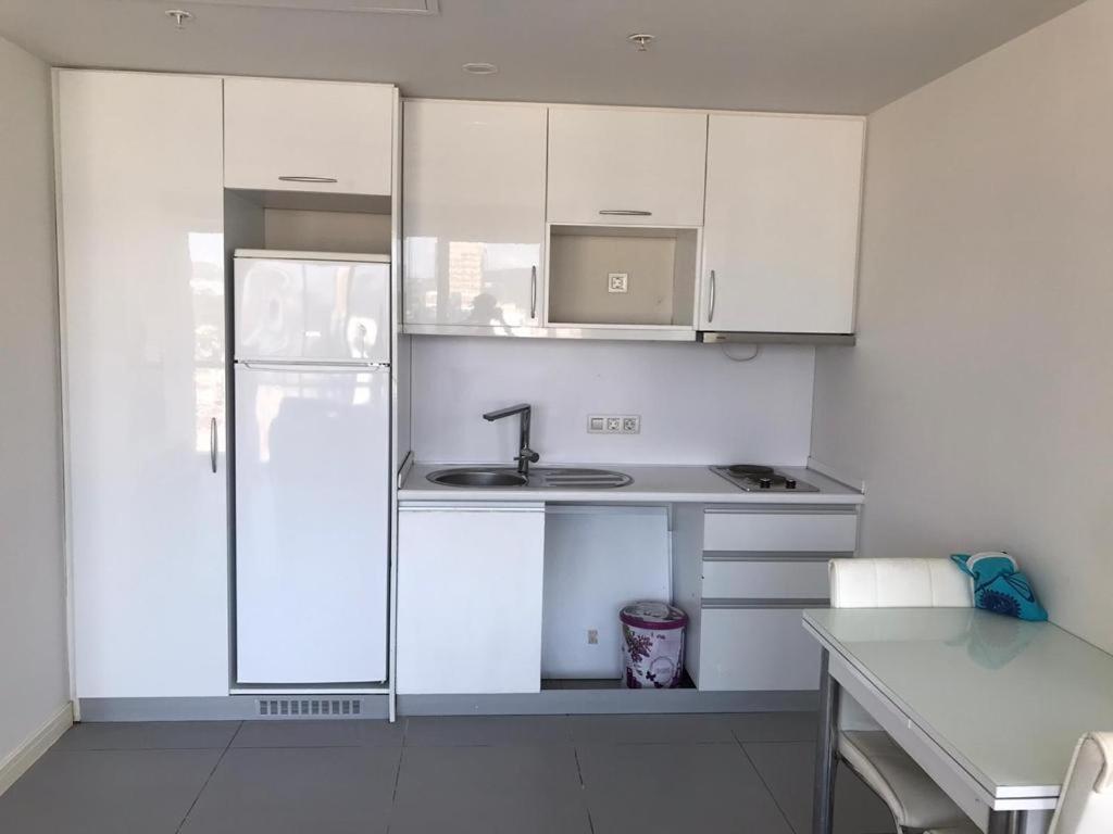 a white kitchen with a sink and a refrigerator at MANDRAKE in Istanbul