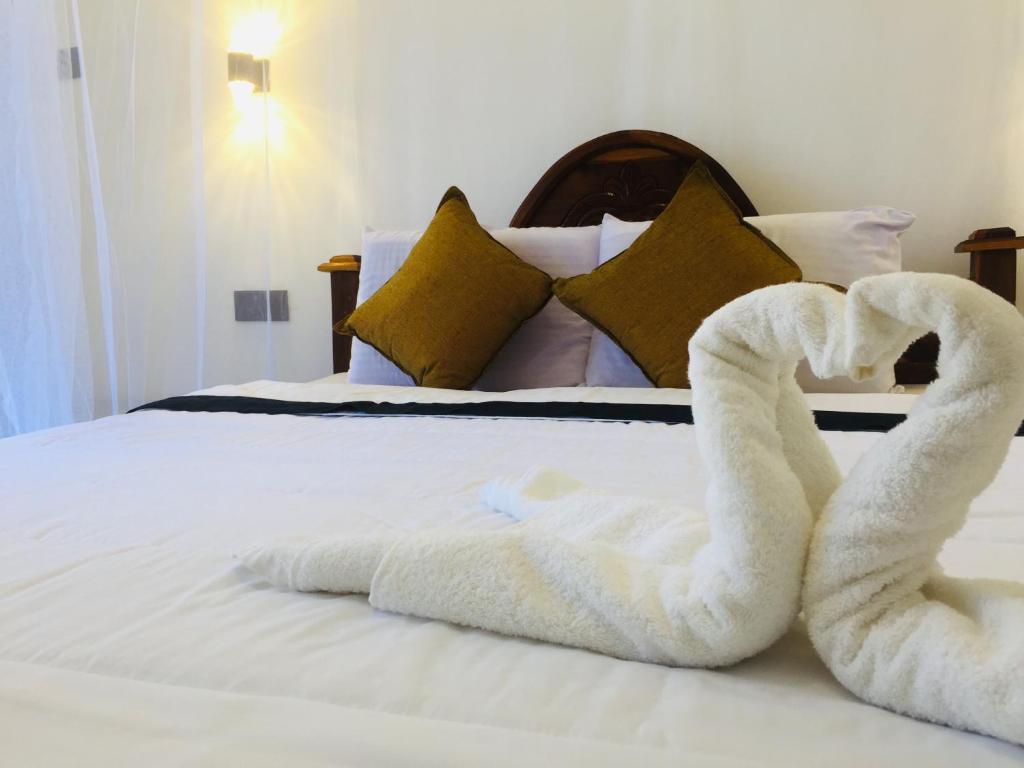 Postel nebo postele na pokoji v ubytování Sapumal palace
