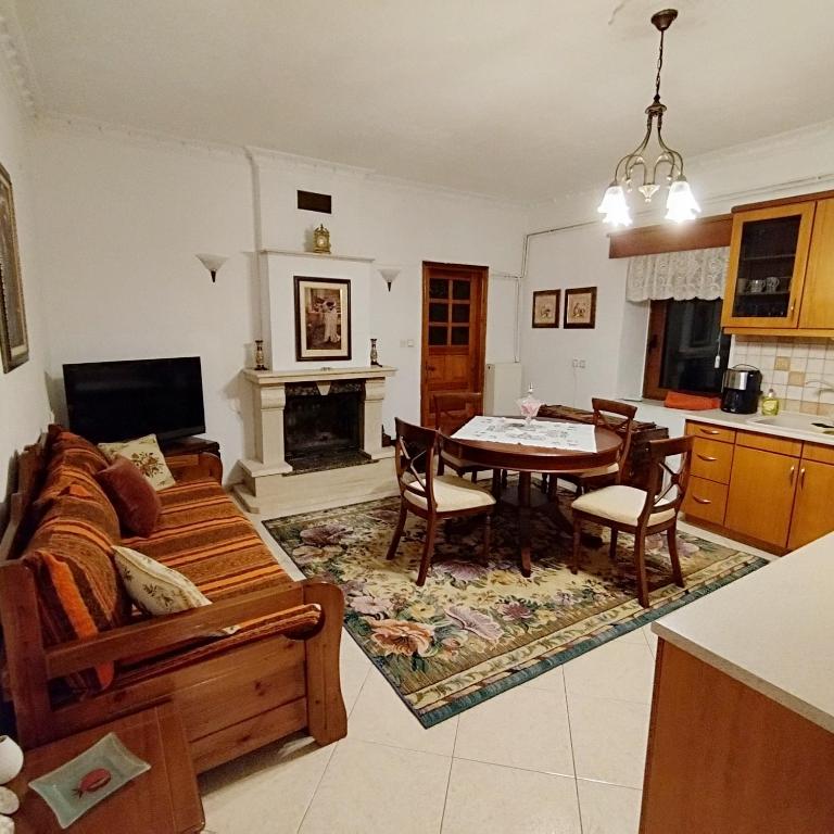 a living room with a couch and a table at Grevena country House in Kalirákhi