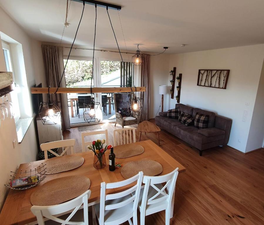 a living room with a table and a couch at Ferienwohnung Edelbach Deluxe in Sattendorf