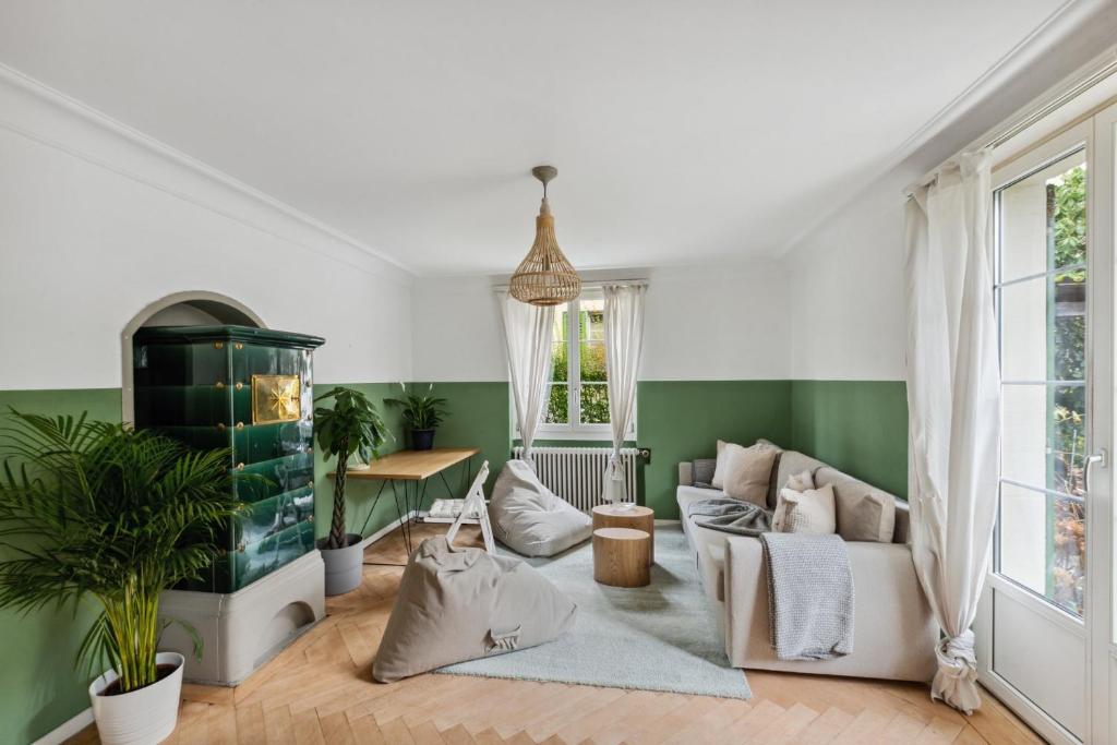een woonkamer met een bank en een tafel bij Centrally located House with garden in Zürich