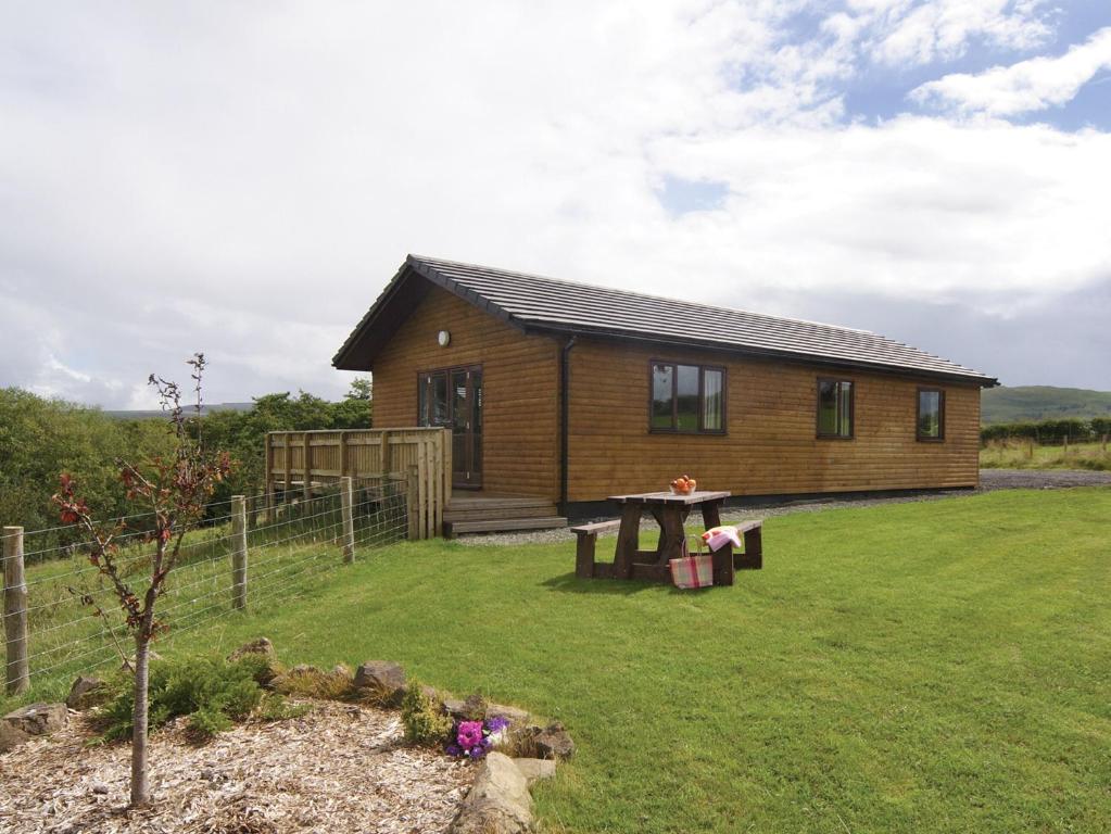 a log cabin with a picnic table in the yard at Ithon Bank - Hw7478 in Penybont