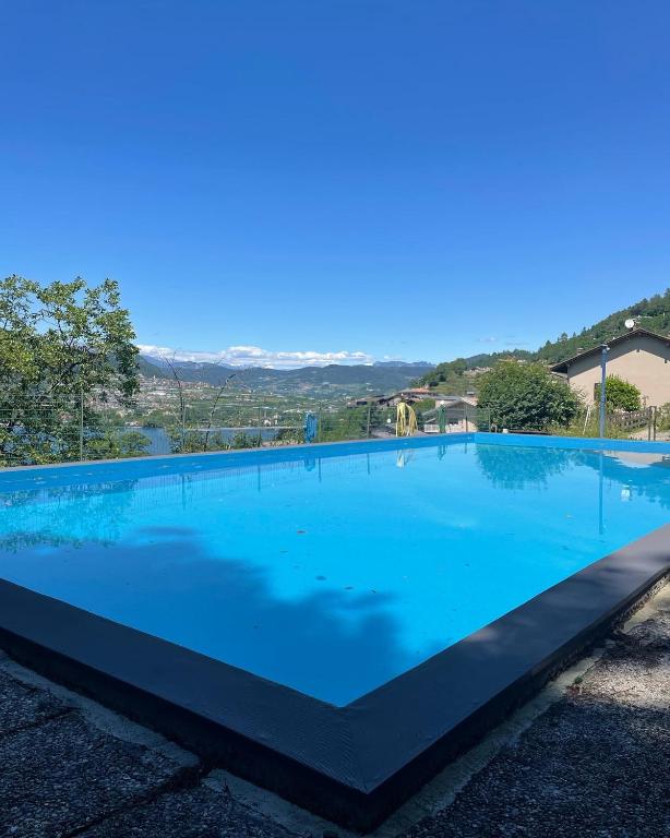 a large blue swimming pool with aizonsizons at Lake Apartment Ischia White, Lago di Caldonazzo in Tenna 