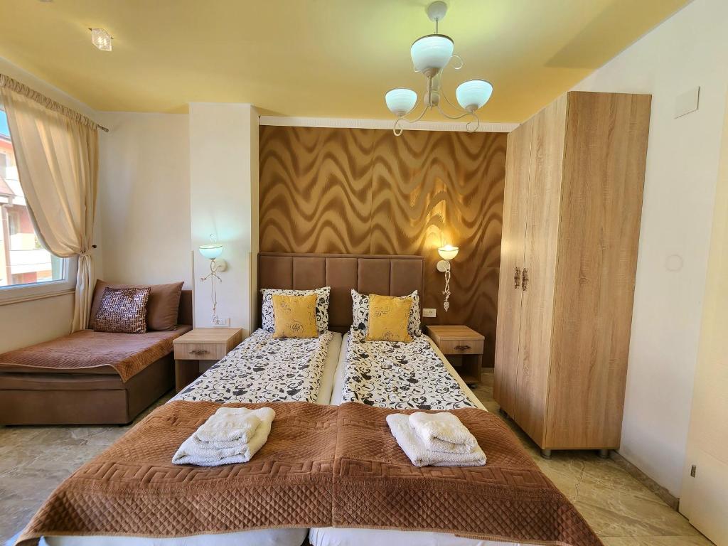 a bedroom with a large bed and a couch at Apartments Ohrid Lake in Ohrid