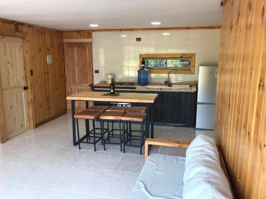 a kitchen with a table and some chairs in it at RAMAL LODGE CONSTITUCION in Constitución