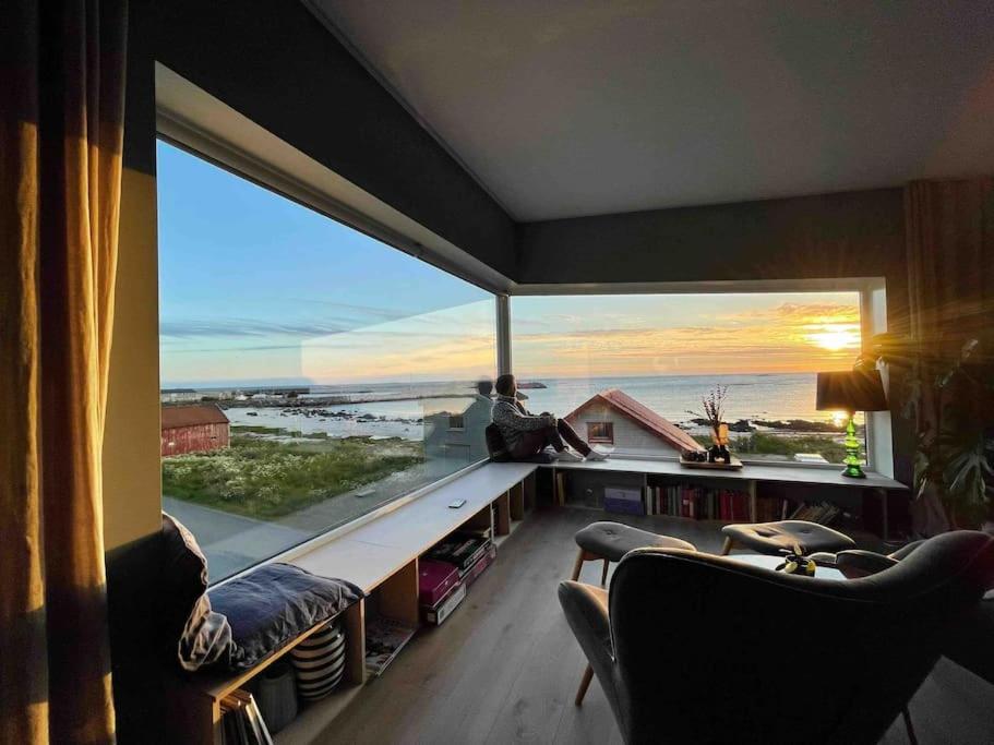 a room with a large window with a view of the ocean at Fabrikken in Bleik