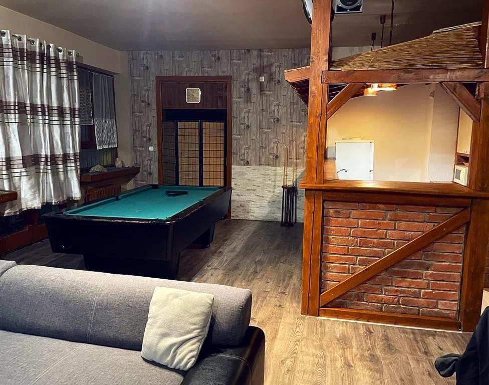 a living room with a pool table and a couch at Ubytovanie KAMENICA 
