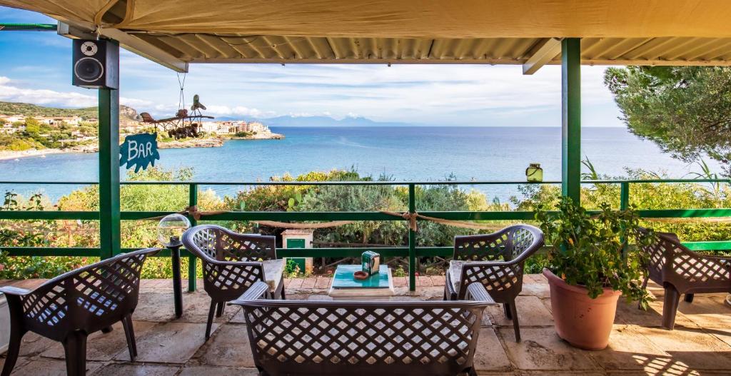 a patio with a view of the ocean at Villaggio Residence Pietra Grigia in Marina di Camerota