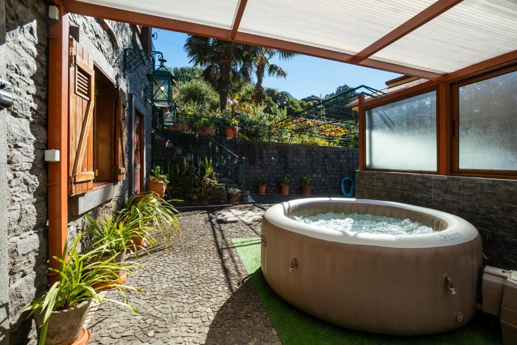 a hot tub in the courtyard of a house at Stone House ''Vista'' By Atlantic Holiday in São Vicente
