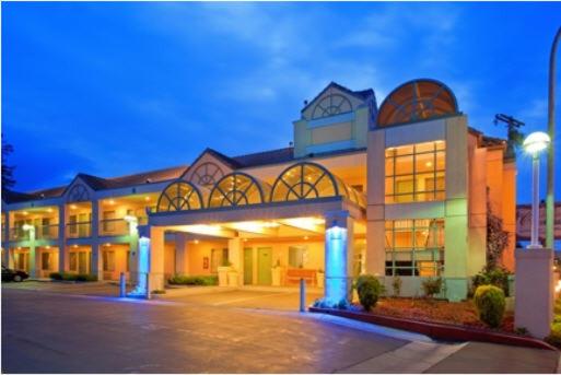 a large building with a lot of windows at Atherton Park Inn and Suites in Redwood City
