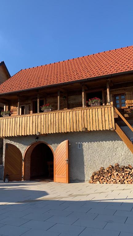 a building with a wooden door and a balcony at Mountain Luxury Lodges in Slavetić