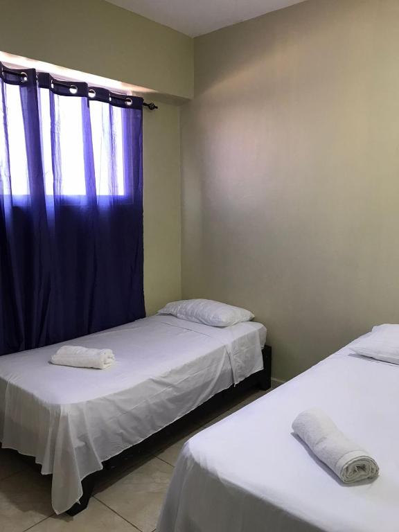 Postel nebo postele na pokoji v ubytování Hostal Magisterial Santo Domingo