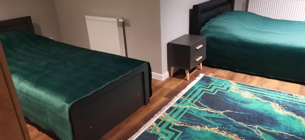 Łóżko lub łóżka w pokoju w obiekcie Apartamenty Green&Blue w Węgorzewie- GREEN