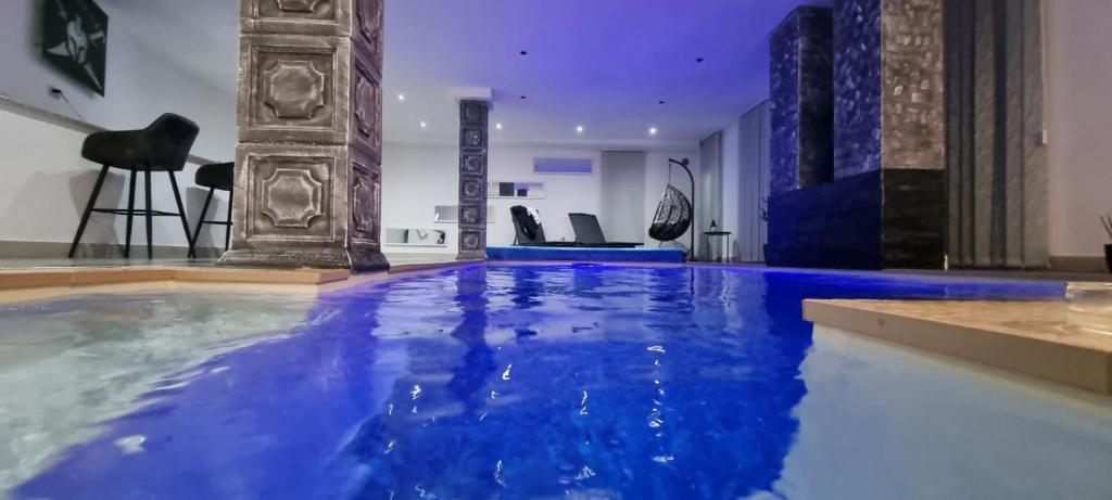 Imperial exclusive apartments في فليكا كلادوشا: حمام سباحة كبير مع الماء الأزرق في الغرفة