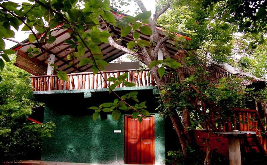 a building with a balcony on top of it at Sigiri Holiday Villa in Sigiriya