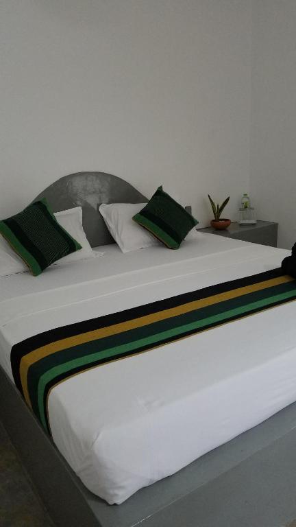Postel nebo postele na pokoji v ubytování Sigiri Holiday Villa