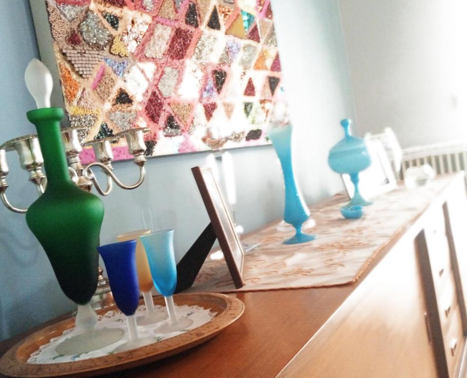 a group of vases sitting on a wooden table at Mid Century Modern Apartment - Atelier in Olympia