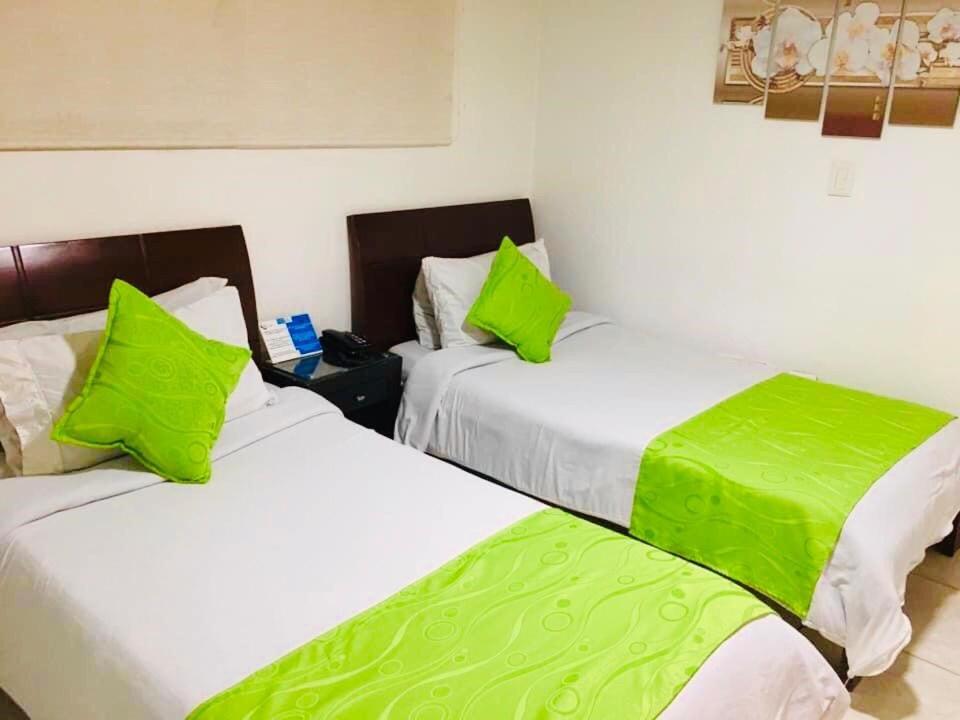 Postel nebo postele na pokoji v ubytování Hotel Fénix Real Bogotá