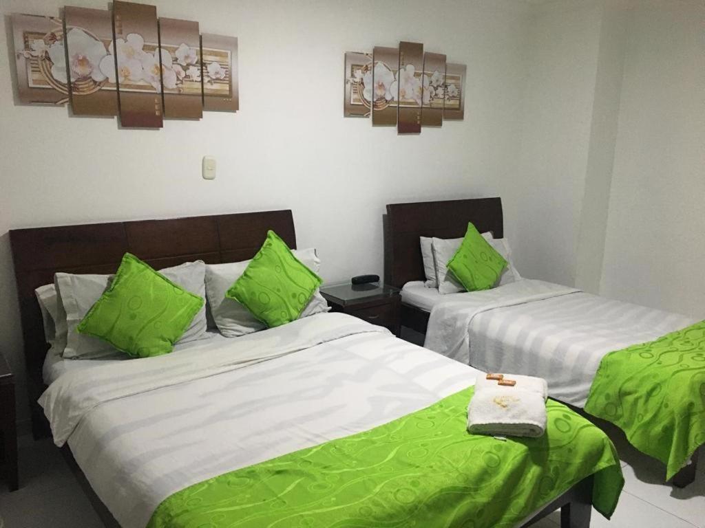 Postel nebo postele na pokoji v ubytování Hotel Fénix Real Bogotá