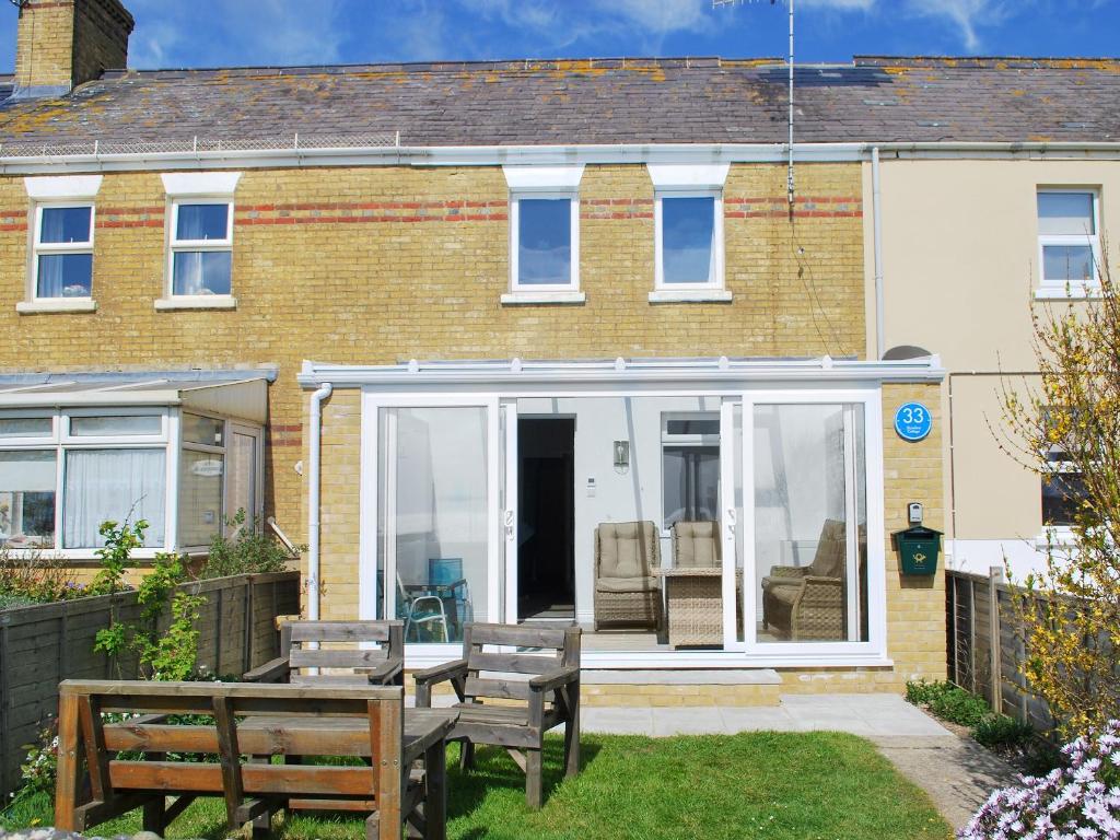 a extension to a house with benches in the yard at Shoreline in Sandown