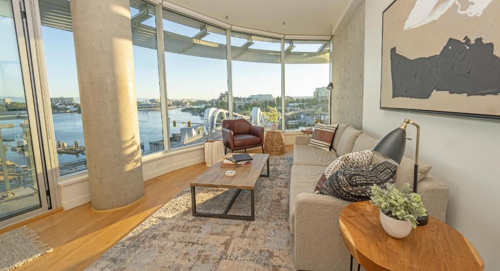 a living room with a view of the water at Janion Sky by IRIS PROPERTIES! in Victoria
