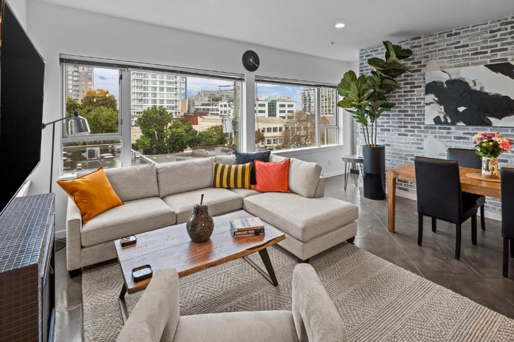 ein Wohnzimmer mit einem Sofa und einem Tisch in der Unterkunft Soho Penthouse by IRIS PROPERTIES! in Victoria