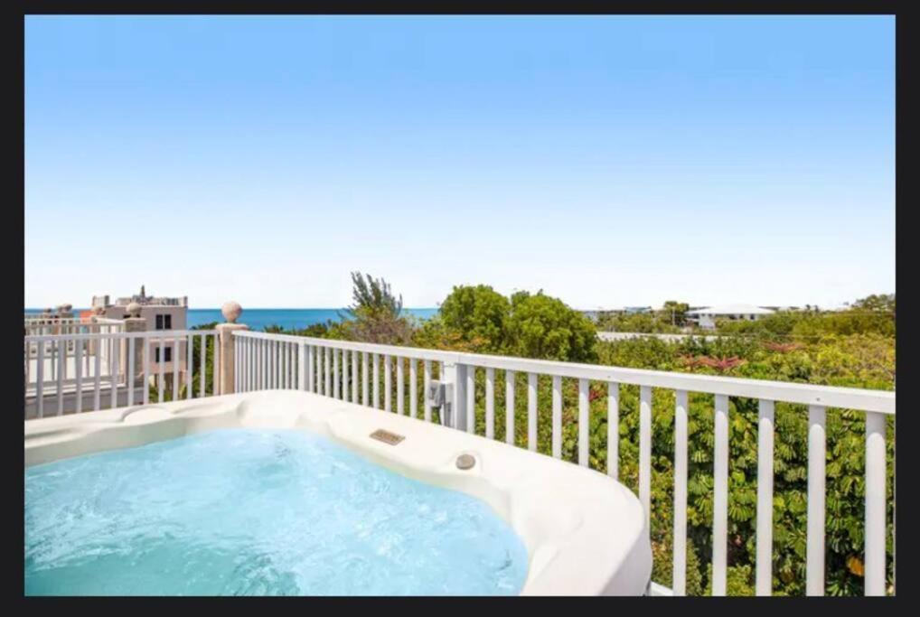 a hot tub on a balcony with the ocean in the background at Florida Keys Wellness Gem in Marathon