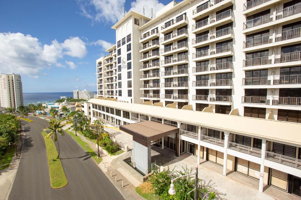 a large white building with a street in front of it at The Bayview Hotel Guam in Tumon