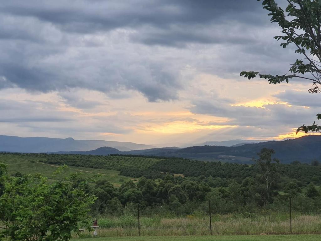 a view of a field with mountains in the distance at KatiKati Eco Lodge in White River