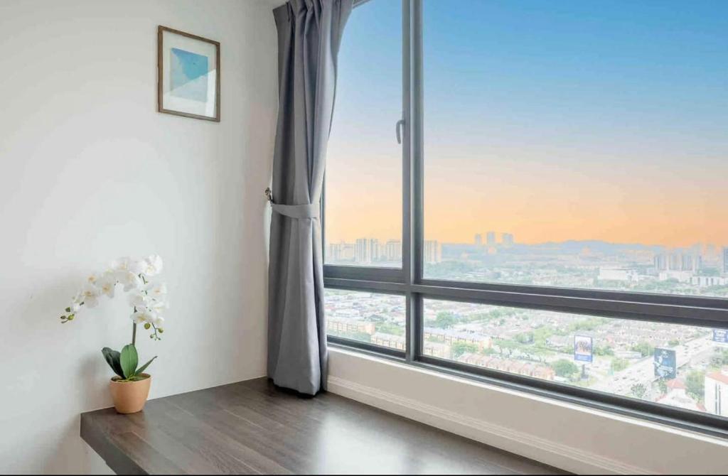 a room with a large window with a view at Greenfield Residence At Sunway City by Nexx Field in Petaling Jaya