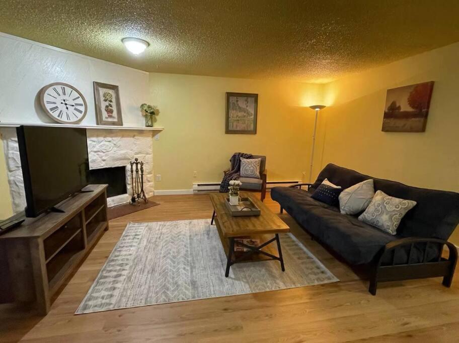 a living room with a couch and a fireplace at Livable B in kirkland in Kirkland