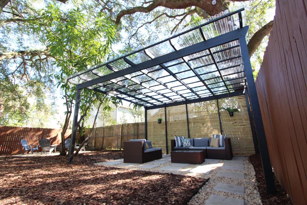 a pergola with two couches on a patio at 3 Bedroom Modern Ybor City Home- Pet Friendly in Tampa