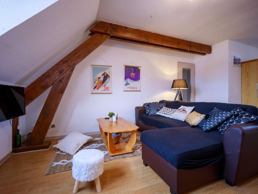 a living room with a blue couch and a table at Appartement Saint-Lary-Soulan, 1 pièce, 6 personnes - FR-1-296-454 in Saint-Lary-Soulan