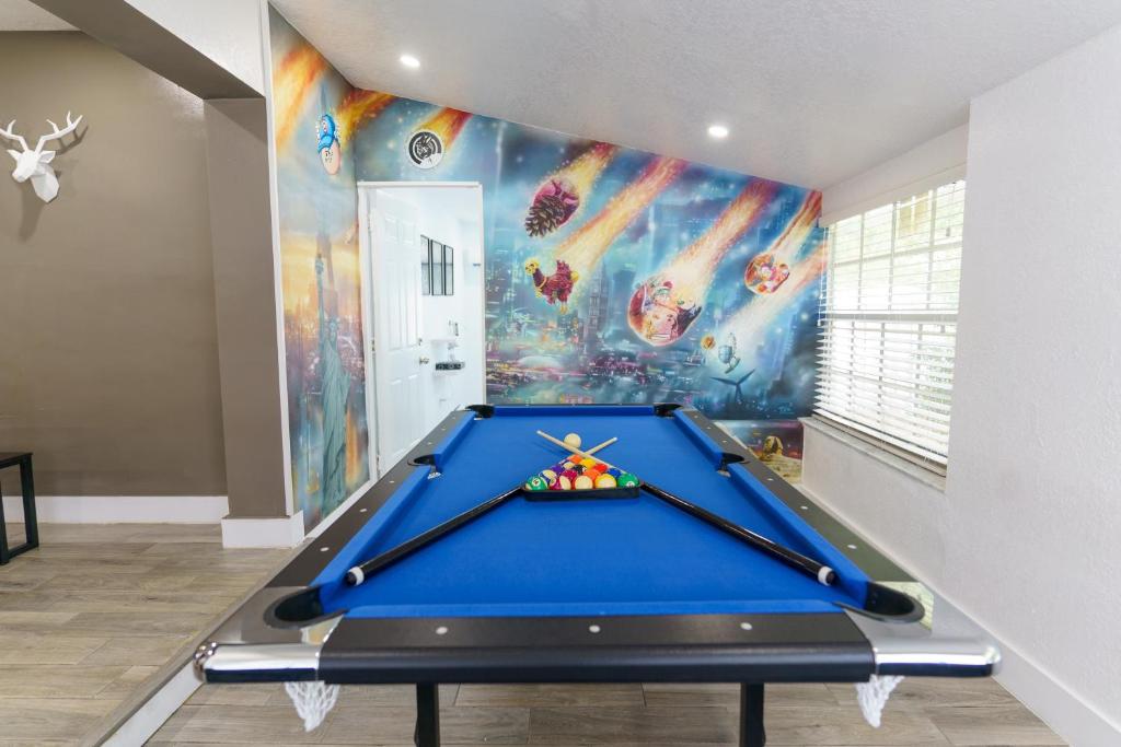 a pool table in a room with a mural at Metaverse Manor Hardrock Stadium in Miramar
