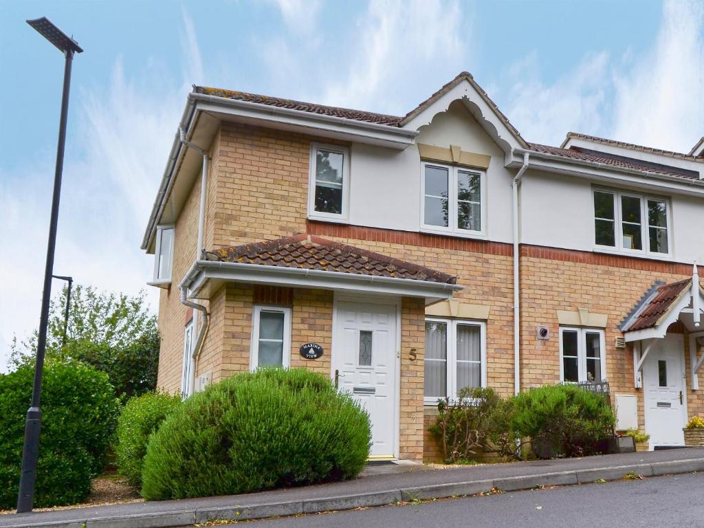 a brick house with a white door at Marina View in East Cowes