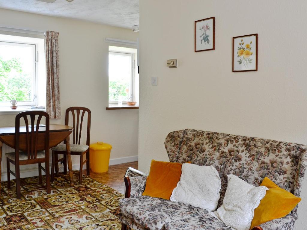 a living room with a couch and a table at Strathspey in Largs