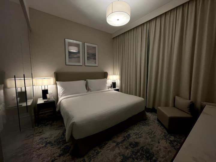 A bed or beds in a room at The Address Residence Fujairah
